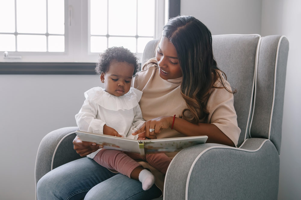 A mother reading to her infant daughter