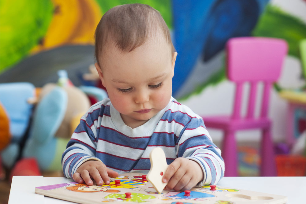 Young child playing with a puzzle